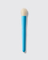 Blue makeup brush with beige bristle head on a light gray background
