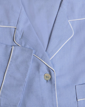 Close-up of a light blue pajama set with white piping