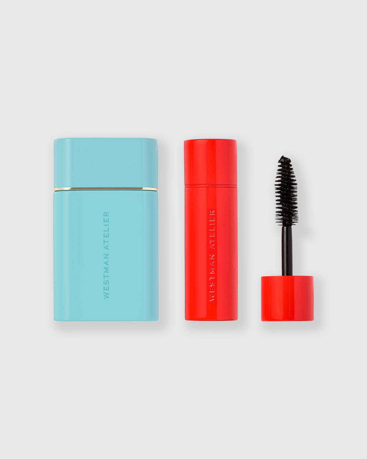 Bronzer in blue packaging and mascara in red tube on a light gray background.