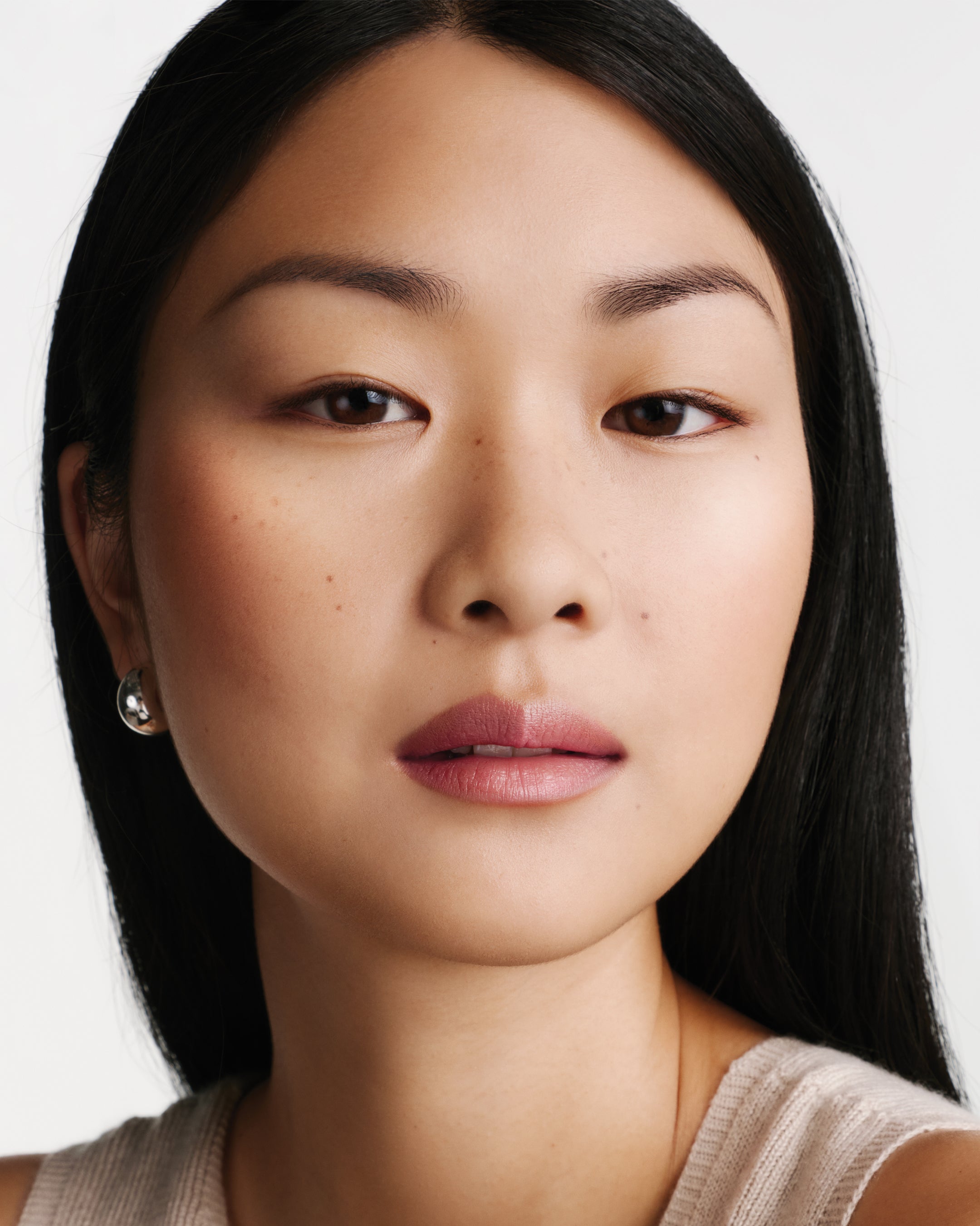 Model wearing HydroBalm in English Rose.
