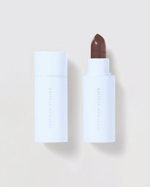Brown lipstick on a beige background.
