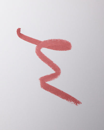 Lip liner swatch in Je Reve on grey background.
