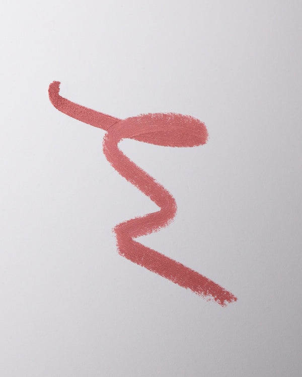 Lip liner swatch in Je Reve on grey background.
