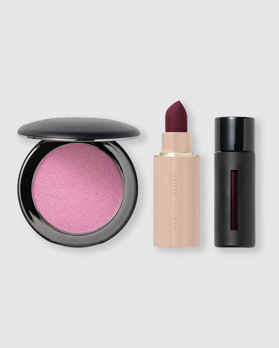 Makeup products including a pink blush, lipstick, and black lip product on a light gray background