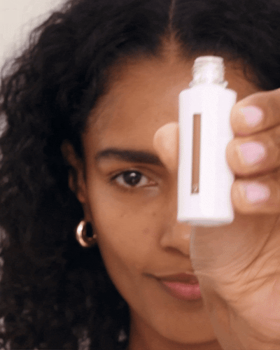 Model applies Vital Skincare Concealer to her undereyes.