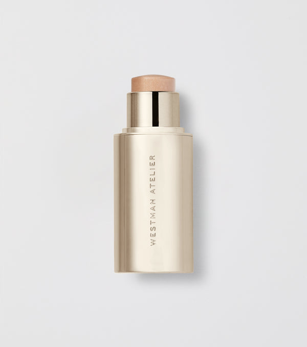 Makeup stick with visible brand name on a light gray background