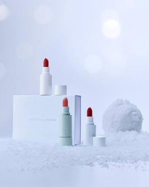 Lipstick set against a white background with snow.