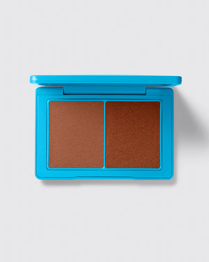 Blue compact with brown makeup on a white background