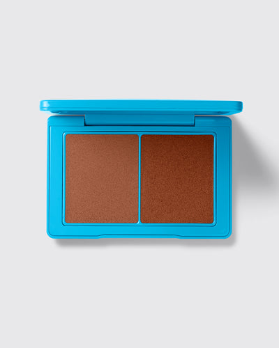 Blue compact with brown makeup on a white background