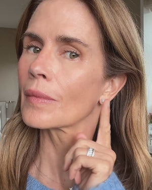 Gucci Westman applies Lit Up Highlight Stick in Garconne to the top of her cheekbones.